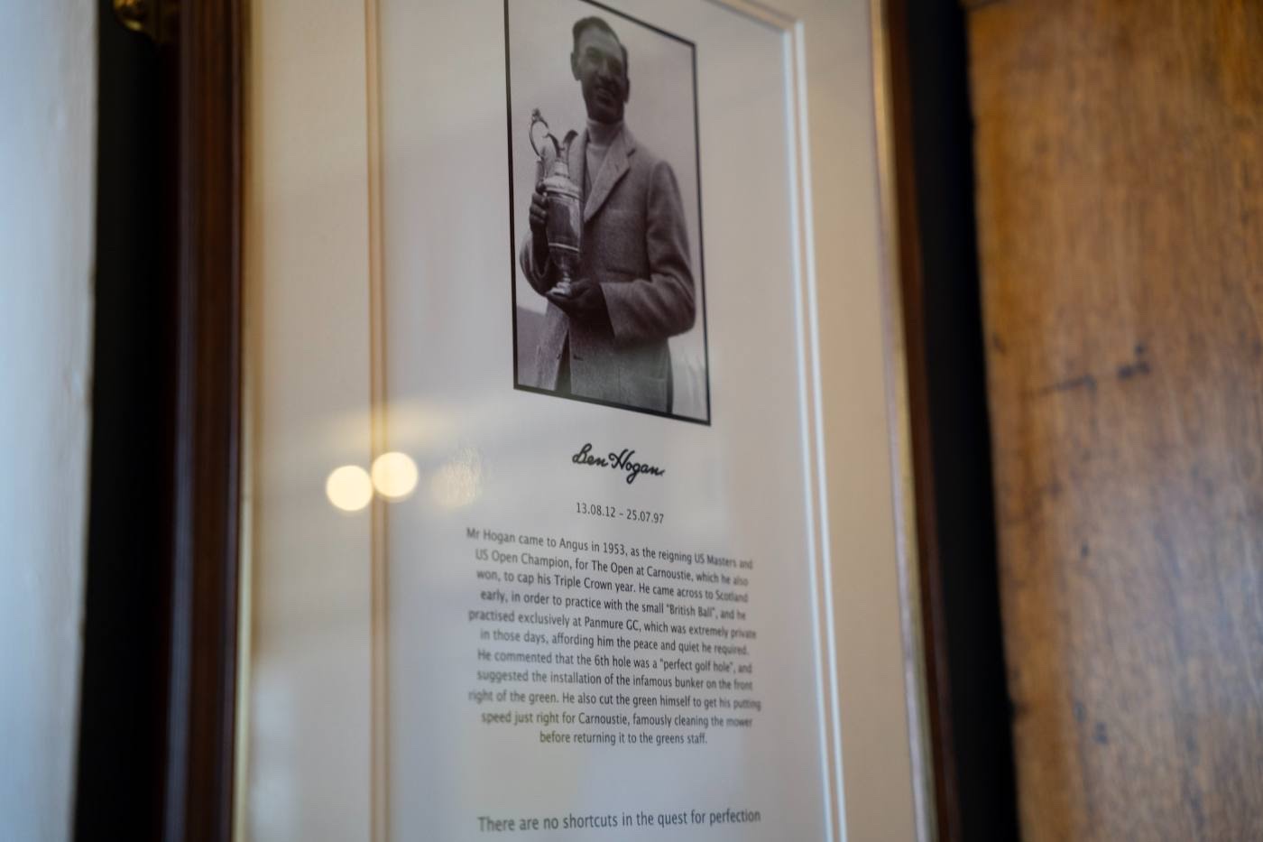 The framed Hogan tribute in the clubhouse: a photograph of him holding the Claret Jug, his signature beneath it